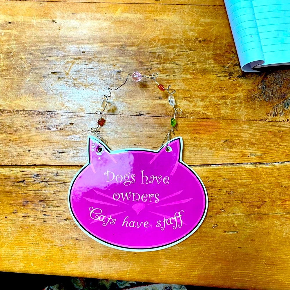 “Dogs have owners and cats have staff” hanging decoration. 7” wide x 5.5” length